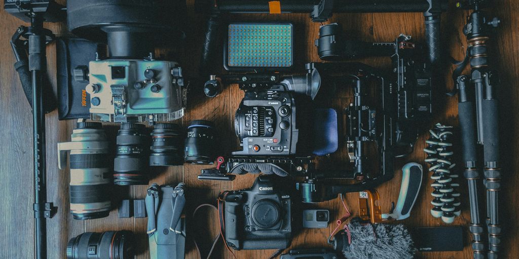 flat lay photography of cameras and camera gear