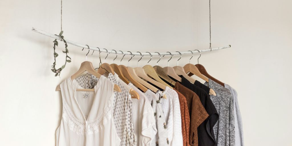 assorted clothes in wooden hangers