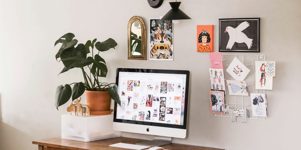 silver iMac on wooden desk