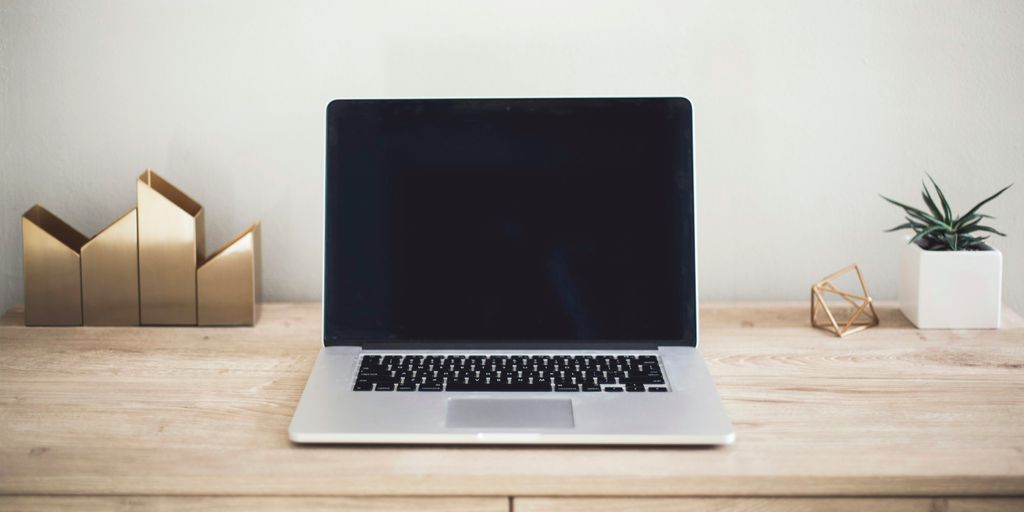 MacBook Pro on top of brown table