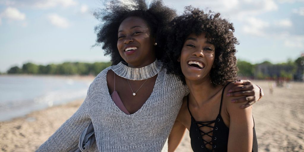 photo of woman beside another woman at seashore