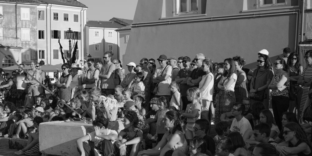 a crowd of people sitting on the side of a road