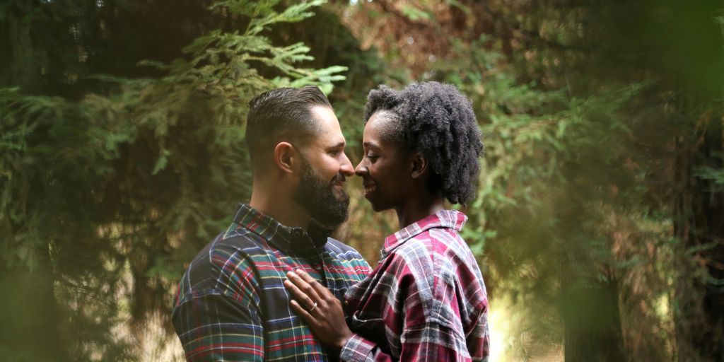 man and woman wearing button-up sports shirt on the center of trees