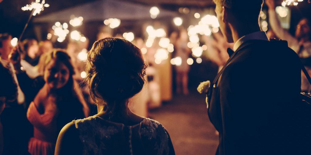 man standing near the woman walking in party during nighttime